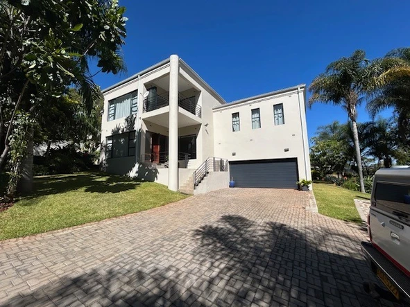Stunning Split Level Home Set Is A Beautifully Crafted Garden With Water